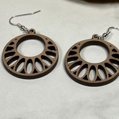 Pair of walnut circle burst earrings laying on white background