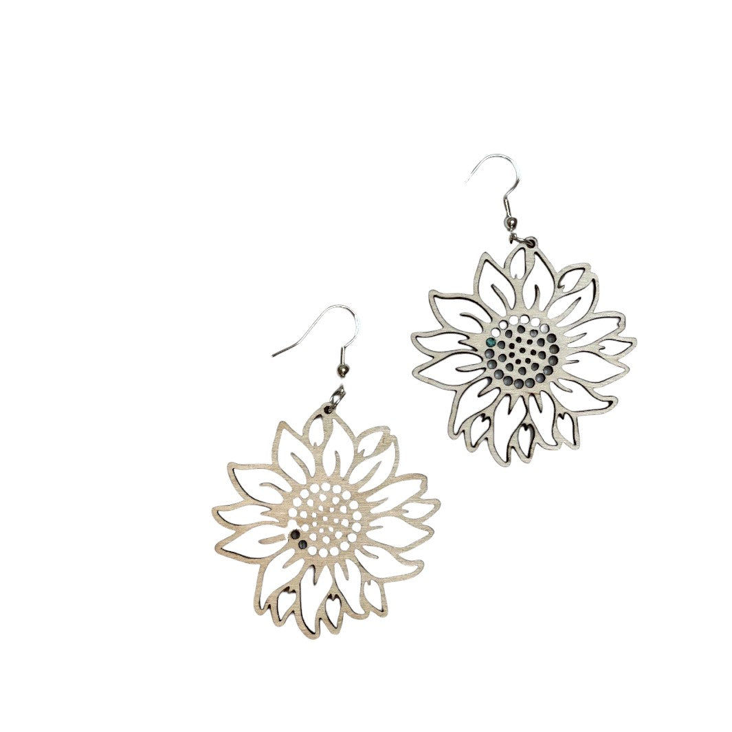 White background with a pair of lightweight wooden earrings that are sunflowers