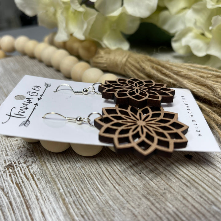 close up photo of starburst, laser cut, wooden earrings, by trumm and co